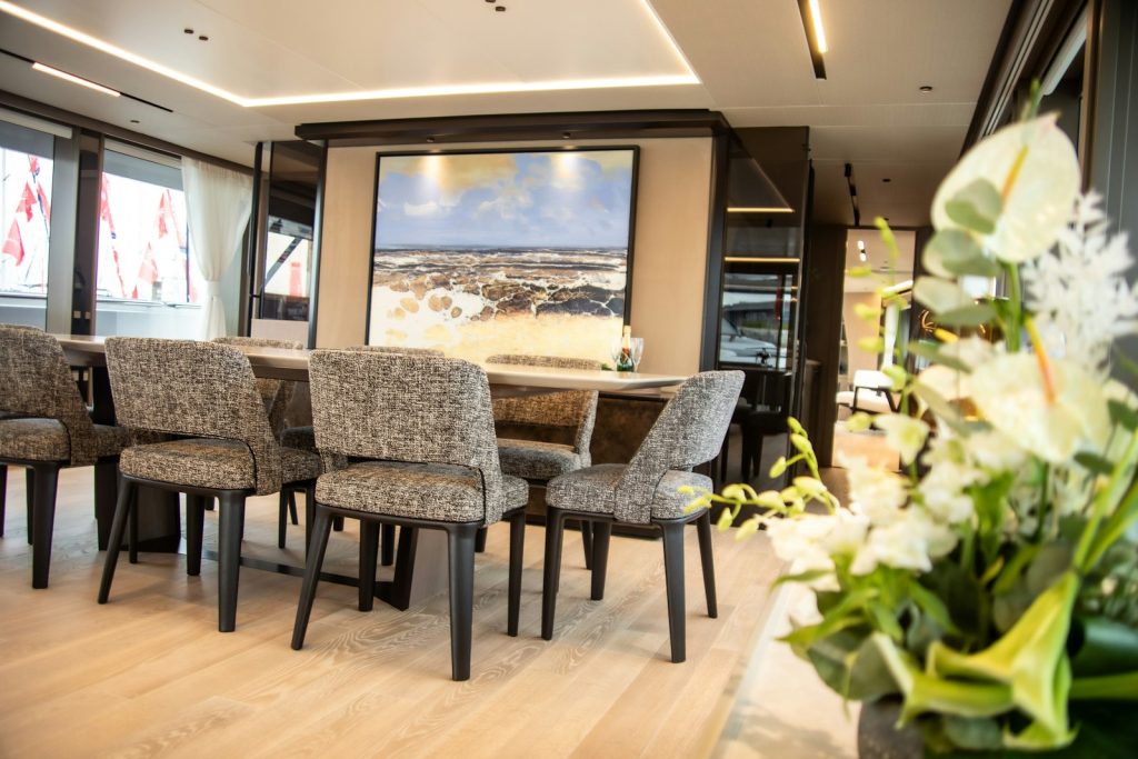 a dining room with a large painting on the wall
