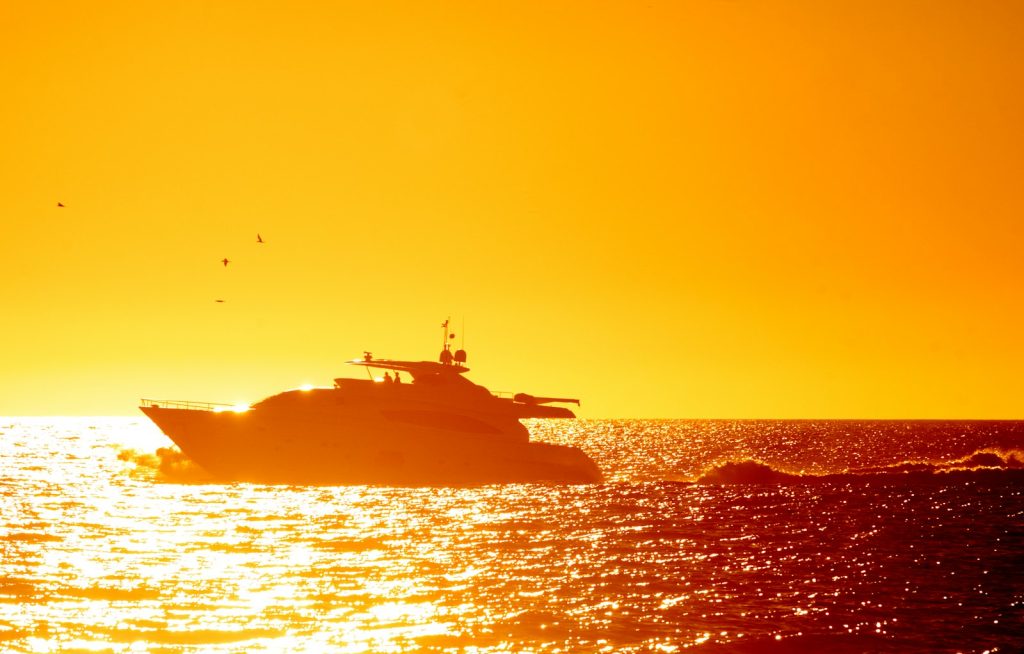 A boat is in the water at sunset